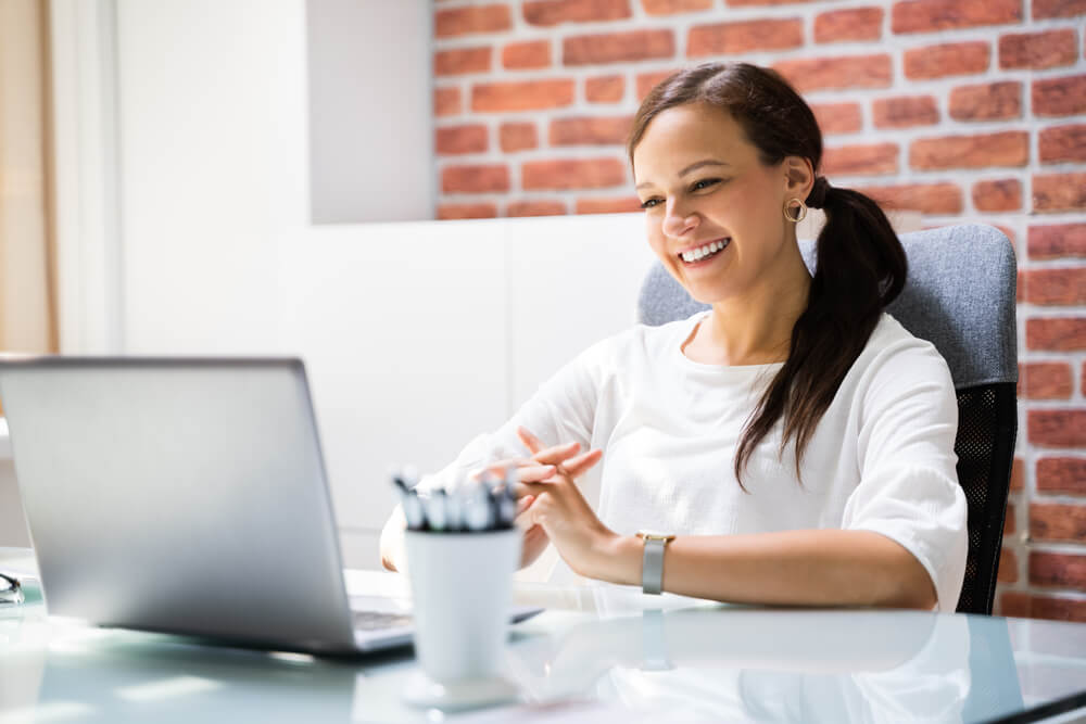 Employer interviewer smiling at her laptop